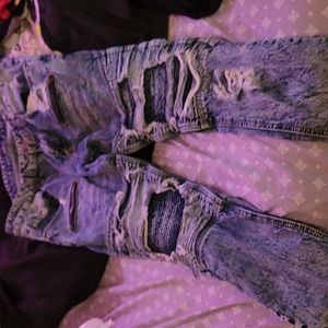 Ripped blue jeans with zippers